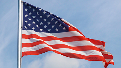 American flag with blue sky